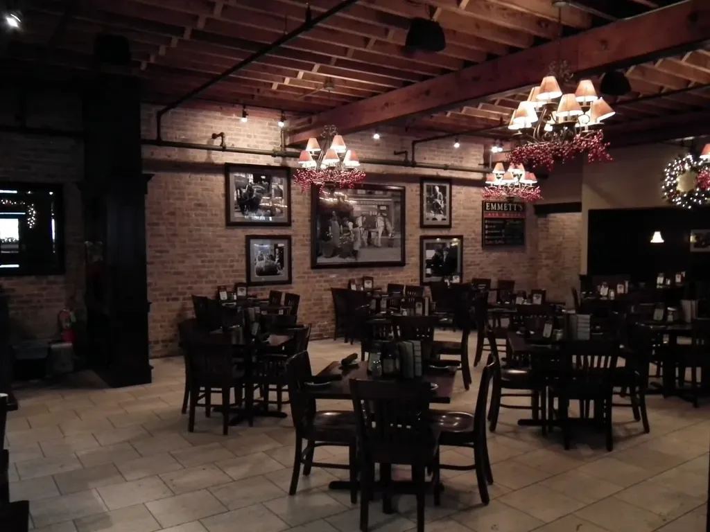 Traditional pub dining room with brick wall and framed photographs