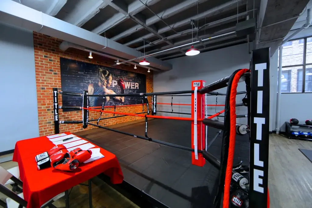 Boxing training facility with ring and branded mural
