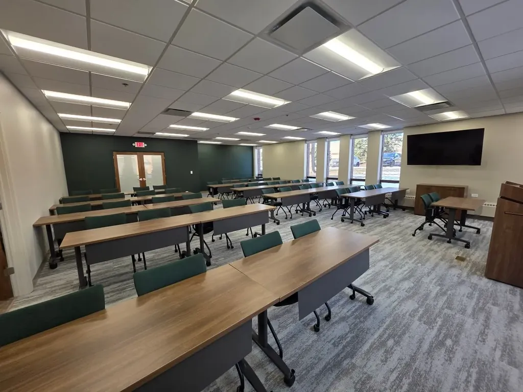 Conference room with U-shaped seating and mounted television